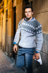 Confident and handsome young man in the street