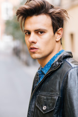 Confident and handsome young man in the street