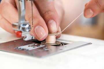 Macro close up of tailor threading sewing machine