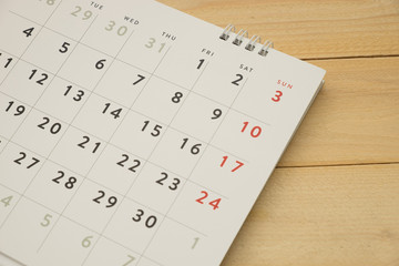 desktop calendar putting on wooden background. this image for business accessory concept
