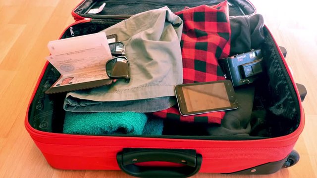 Young guy are packing suitcase for a journey. Dreams about travel.