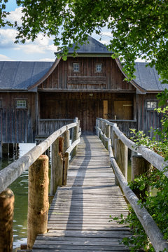 Footbridge leading to old wooden boats house on German lake