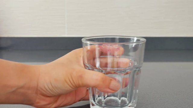 Drinking water from a glass, finish a glass of water