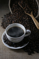 Coffee cup and coffee beans on Burlap Texture