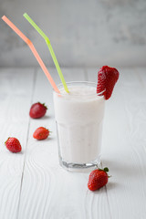 strawberry milkshake on a white wood background. selective focus