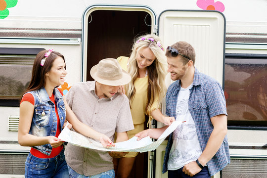 Happy Friends Checking The Map And Planning Their Route. Trip, Traveling, Holiday, Vacation Concept.