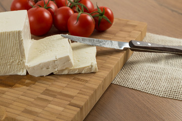 organic cheese and tomatoes on wooden table