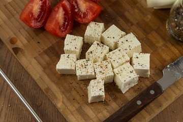 organic cheese and tomatoes on wooden cutting board