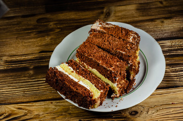 Biscuit cake in plastic container on wooden table