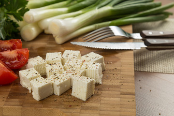 organic cheese and tomatoes on wooden cutting board