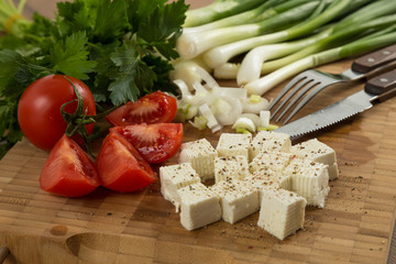 organic cheese and tomatoes on wooden cutting board