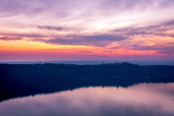 Castel Gandolfo town above the Albano Lake, outside Rome, Italy, with Papal summer residence visible, at sunset