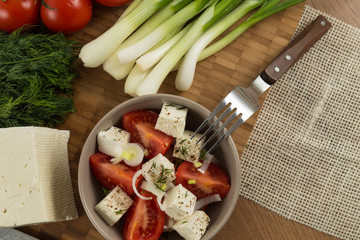 organic cheese and tomatoes on wooden table top view