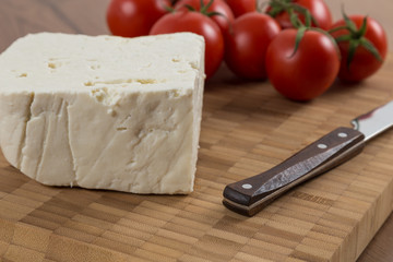 organic cheese and tomatoes on wooden table