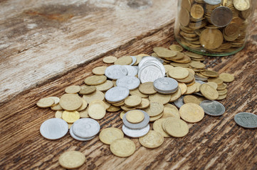 Ukrainian coins in a jar on a wooden background