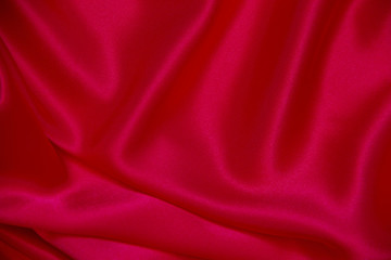 Naklejka na ściany i meble Red cloth waves background texture.