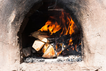 Firewood burns in an ancient stove