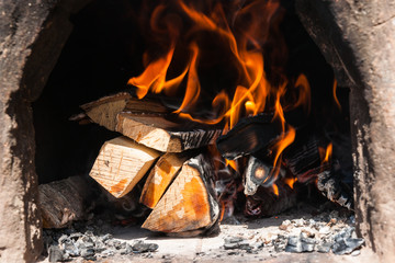 Firewood burns in an ancient stove