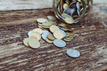 Ukrainian coins in a jar on a wooden background