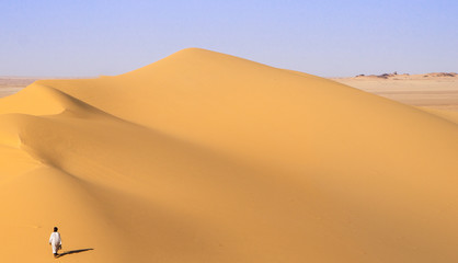 Touareg walking over a dune in Mount Gauthier  - Algerian Desert - Tassili Tenere