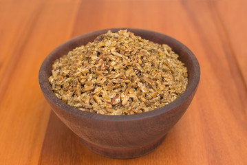 Freekeh in a wood bowl in wood background