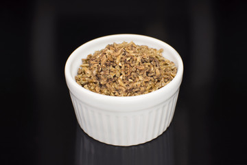 Freekeh in a ramekin in black background