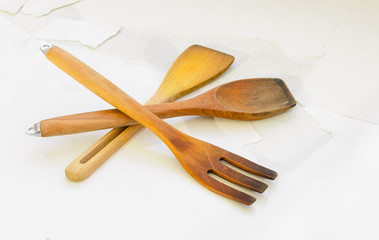 wooden kitchen utensils on white cracked floor