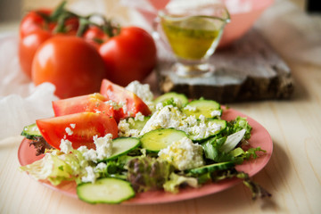Tasty Greek salad with lettuce, cherry tomatoes and feta cheese