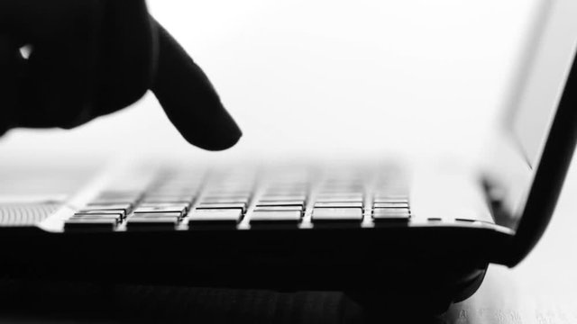 Silhouette video man presses by finger on the keyboard key on the electronic device but it is broken, he is nervous and angrily presses harder on button
