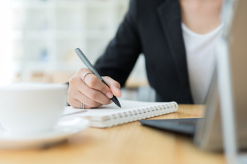 Businesswoman using pen for note to do list concept,selective focus.