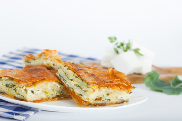 Plate of Freshly baked Serbian Traditional Zeljanica Spinach-cheese Pie slices
