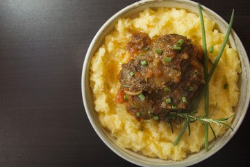Corn meal with oxtail stew. Rabada with polenta. Overview with copy space.