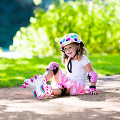 Little girl with roller skate shoes in a park