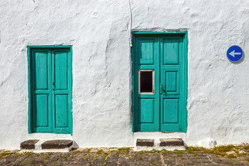 Fototapeta na wymiar green door and window on white wall background