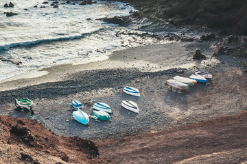 Fototapeta na wymiar Green Lagoon at El Golfo with fishing boats on the beach, Lanzarote Island, Spain