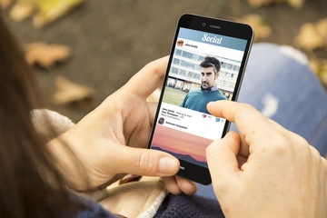woman with social photo network phone in the park