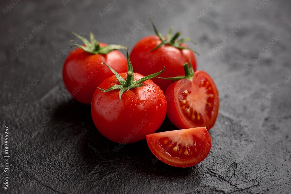 Wall mural tomatoes on dark background