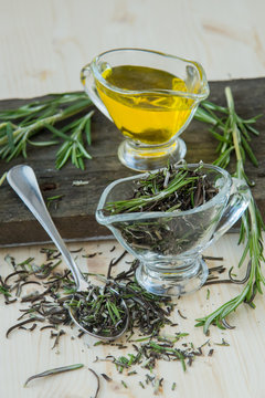 Olive oil with rosemary in a glass jug