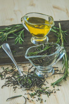 Olive oil with rosemary in a glass jug