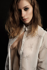 close up portrait of sexy brunette with long hair in white open shirt, look at the camera