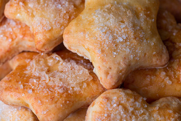 Cookies of different shapes with sugar for a Golden crust.