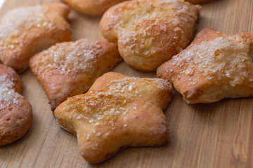 Cookies of different shapes with sugar for a Golden crust.