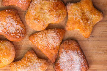 Cookies of different shapes with sugar for a Golden crust.