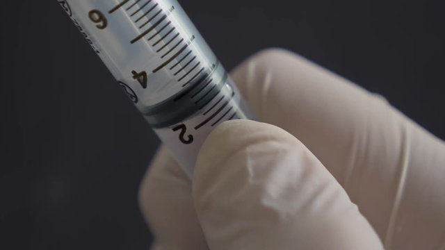 Close up of Medical hand Extracting with hypodermic needle