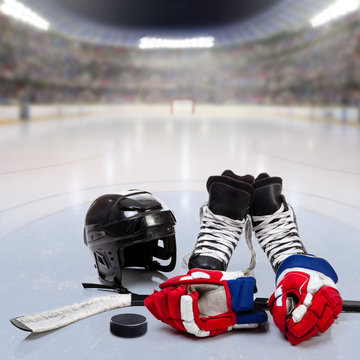 Hockey Equipment on Ice of Crowded Arena