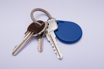 Set of keys with blue tag isolated on white background