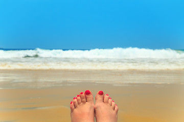 Woman legs on the beach.