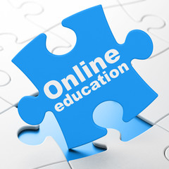 Studying concept: Online Education on puzzle background