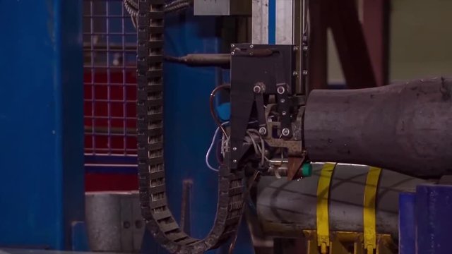 Manufacture of rails for trains and freight wagon, boxcars. Rail manufacturing plant. Stack of steel round bar - iron metal rail lines material for industry construction in warehouse. the big press