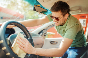 Man cleaning the interior of his car